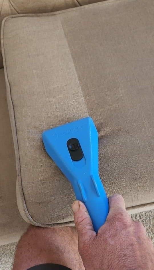 Ultraclean upholstery cleaning tool on a fabric couch