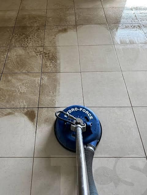 Tile floor cleaning Swan Hill - high-pressure turbo tool lifting dirt from large format tiles, clean tiles on the right