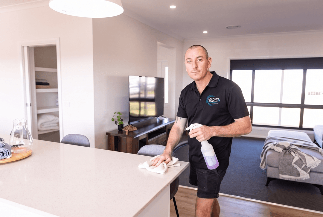 End of lease cleaning checklist Swan Hill - Ultraclean wiping down a kitchen bench during a bond clean